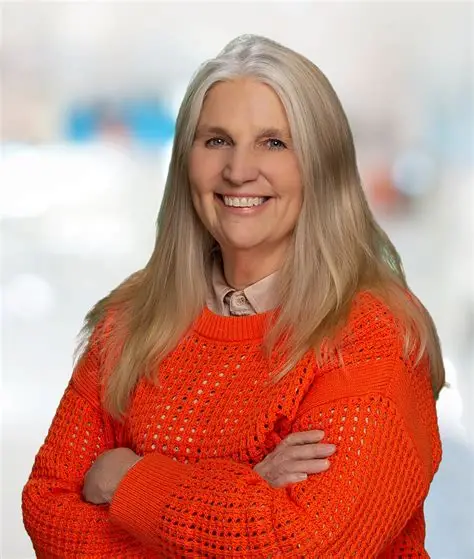Headshot of Dr. Susan Harkema smiling in front of a neutral backdrop.